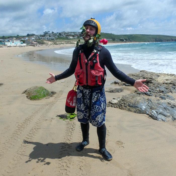 Lee, an experienced coasteering uk guide, joking around after a session at Praa Sands beach in Cornwall.